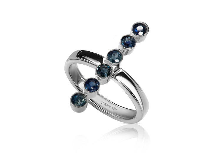 Minimalist sapphire stacking ring photographed on neutral background, handmade in sterling silver by Zanvari Jewelry.