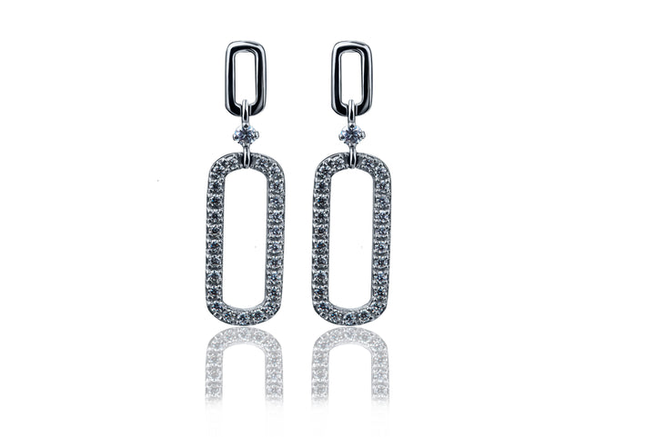 A pair of handmade moissanite earrings crafted in 925 sterling silver, featuring a brilliant sparkle that mimics diamonds. The earrings are meticulously designed by skilled artisans, with a sleek, polished finish and a secure setting that enhances the radiance of the moissanite stones. Elegant, timeless, and perfect for both casual and formal wear.